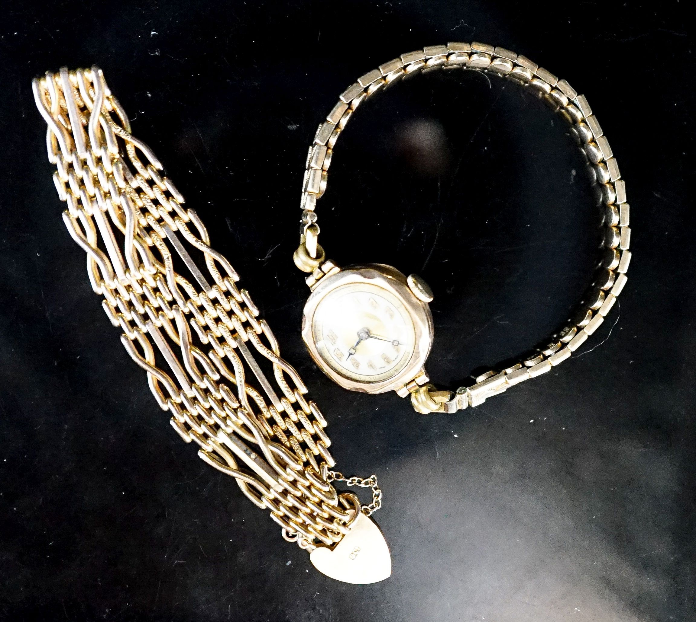 A 9ct. yellow gold chain bracelet, 9.7 grams and a lady's 9ct gold watch on a 9ct and metal core bracelet.